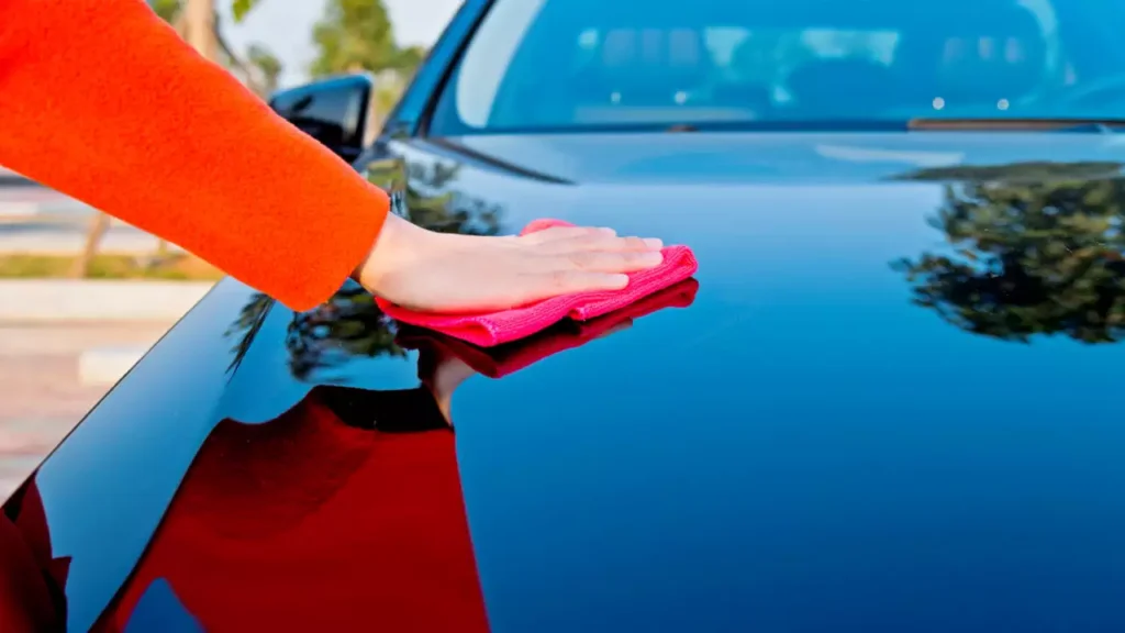 Applying car wax for blue cars